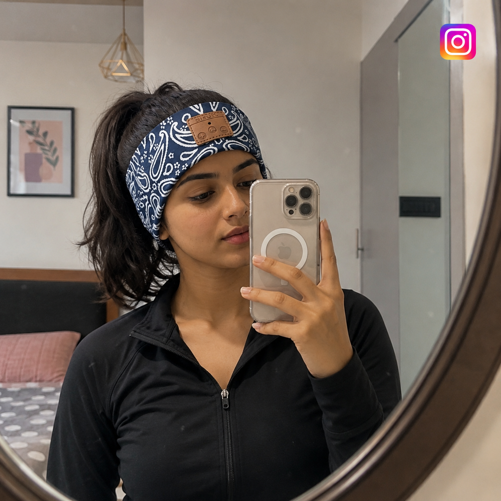 Person wearing a beatband and holding a phone in front of a mirror
